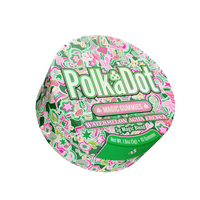 A round container of Polka Dot Magic Gummies, Watermelon Agua Fresca, featuring a vibrant green, pink, and white patterned lid with the brand name in large green letters.