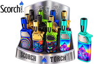 A display of Scorch Torch lighters in multiple vibrant colors and patterns, including blue, green, gold, and psychedelic designs, shown on a white background with the Scorch Torch logo.