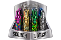 Four metallic disposable vape devices displayed in a silver branded retail stand. The devices feature colorful patterns and metallic finishes in pink, gold, green, and silver, with the SCORCH TORCH branding visible on the stand.